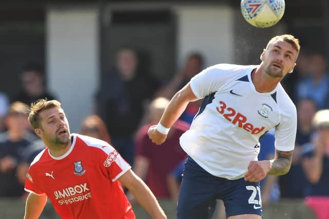 Preston defender Patrick Bauer heads the ball clear with Bamber Bridge's Alistair Waddecar in close attendance during the time the two clubs met