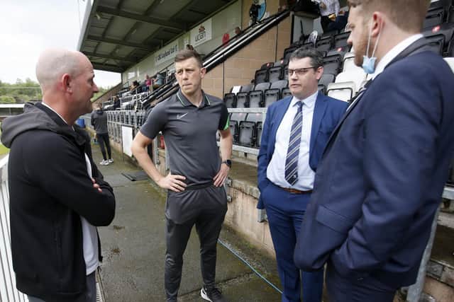Referee Martin Woods (second left) in talks with PNE and Bamber Bridge officials