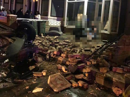 Pictures taken at the scene in Deepdale Road show a black car on its roof on the pavement outside the shop, next to a heap of broken bricks and railings. Pic: Deepdale Community Association