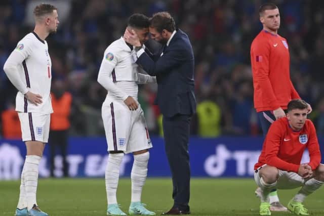Jadon Sancho is comforted by manager Gareth Southgate after the penalty shoot-out nightmare at Wembley.