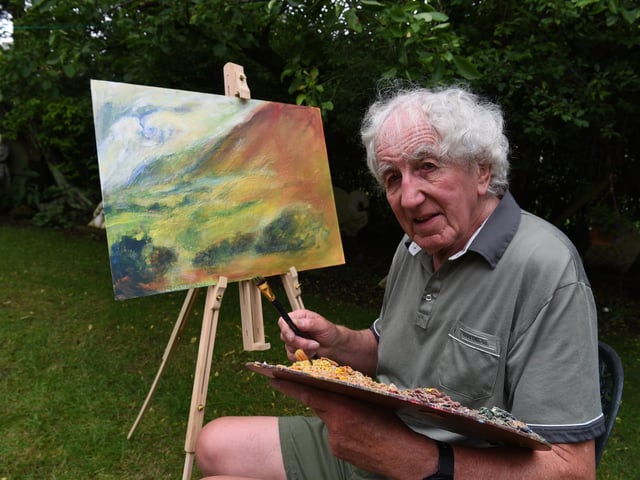 Michael Hipkins pictured at work on a painting Photo: Neil Cross