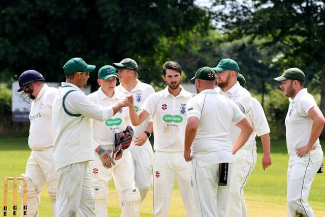 Kirkham and Wesham players celebrate a wicket against Great Eccleston