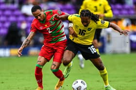 Jamaica’s Daniel Johnson battles with Suriname’s Damil Dankerlui (left)  during the Gold Cup group match at the Exploria Stadium in Orlando, Florida (Photo: CHANDAN KHANNA/AFP via Getty Images)