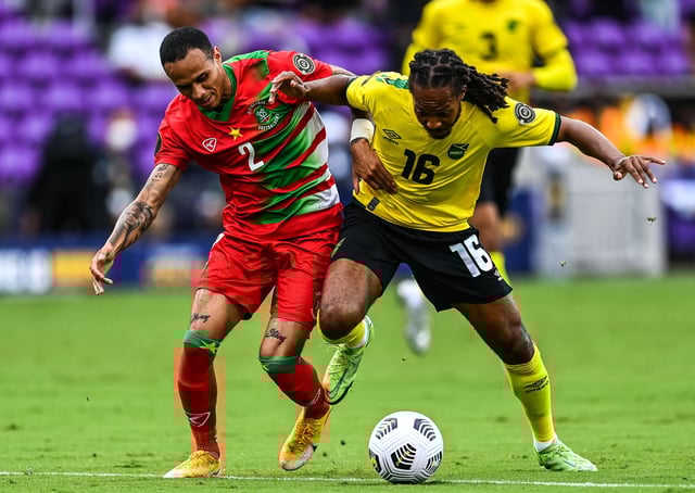 Jamaica’s Daniel Johnson battles with Suriname’s Damil Dankerlui (left) during the Gold Cup group match at the Exploria Stadium in Orlando, Florida (Photo: CHANDAN KHANNA/AFP via Getty Images)