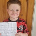Alfie with the letter he has written to Marcus Rashford and his team mates