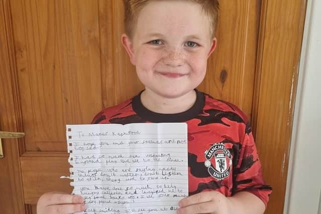 Alfie with the letter he has written to Marcus Rashford and his team mates