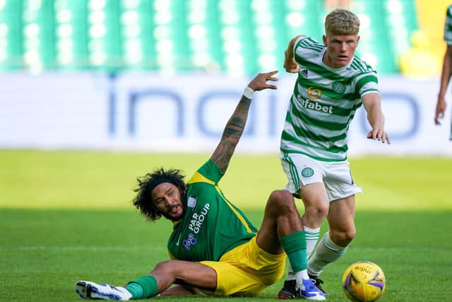 Preston midfielder Izzy Brown slides to tackle Celtic’s Scott Robertson at Celtic Park