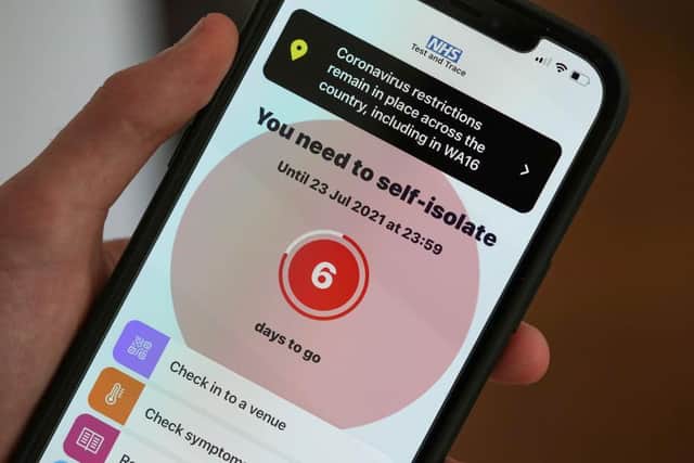 A smartphone using the NHS Covid-19 app alerts the user "You need to self-isolate"