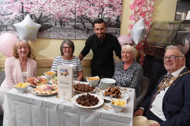 From left:  Susan Forshaw, Marjorie Hayward (Friends for You), Gianni Tsalakos (Majestic Coffee Lounge) Cath Hoyle and Chorley mayor Steve Holgate at the launch of "Talking Tables" (image: Neil Cross)