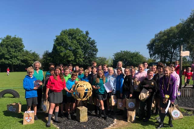 Year 6 pupils from Goosnargh Oliverson's CE school pictured with the globe
