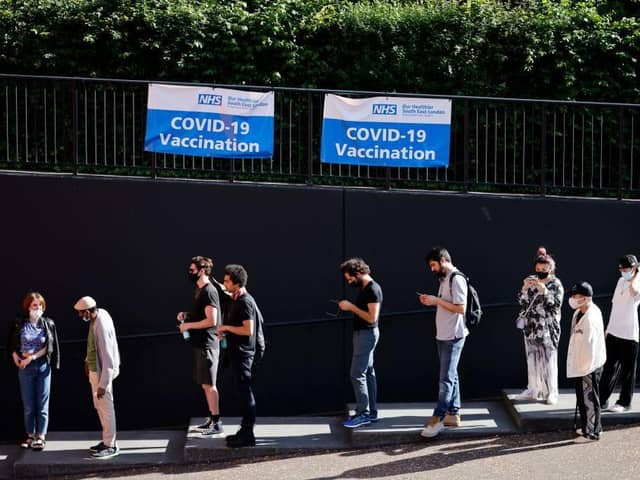 Members of the public queue outside to receive the Pfizer-BioNTech Covid-19 vaccine at a temporary Covid-19 vaccine centre