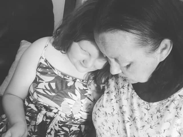 Julianne's mum Tina who has a terminal illness with Isabelle her eldest granddaughter reading Julianne's book.