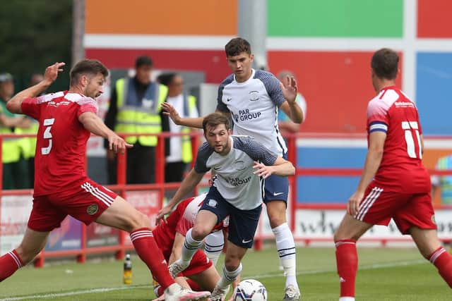 PNE wing-back Tom Barkhuizen looks for a way between two Accrington players