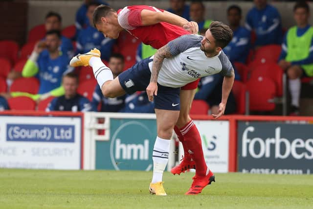 PNE striker Sean Maguire tangles with Accrington defender Ross Sykes