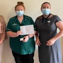 April O’Grady (centre) receives her 10-Year-Service Award for her work at Barchester Healthcare’s Sherwood Court care home in Fulwood, Preston