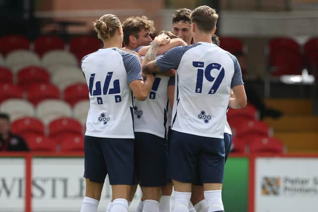 Preston North End players celebrate scoring at Accrington Stanley