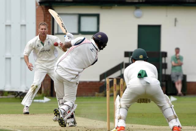 Blackpool pro Shivam Chauhan hits a boundary off the bowling of Leyland's Iain Critchley