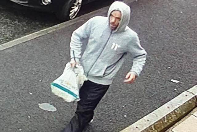 Do you know this man who is wanted in connection with a robbery in Accrington?