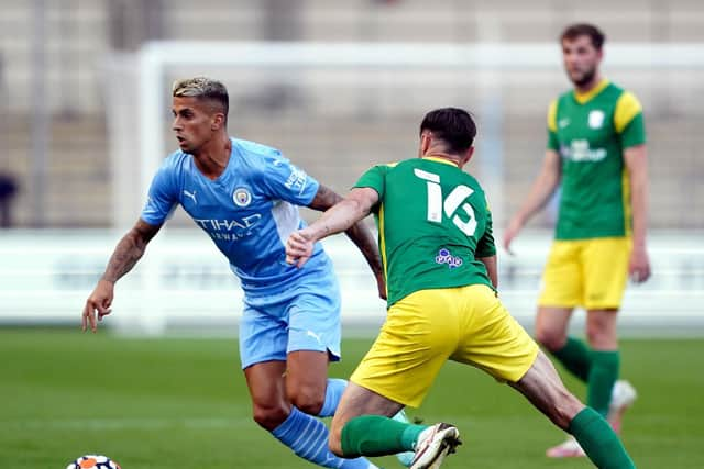 Preston North End left-back Andrew Hughes tracks Manchester City's Joao Cancelo