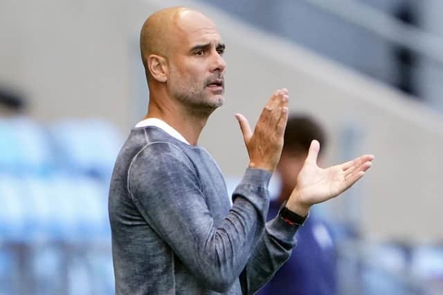 Manchester City manager Pep Guardiola watches his side's friendly against PNE