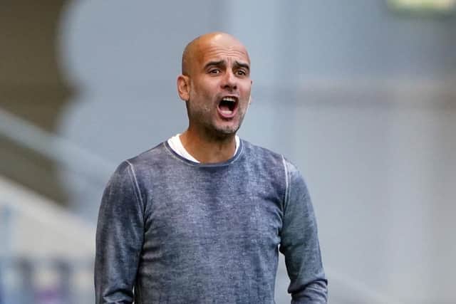 Manchester CIty manager Pep Guardiola watches his side's friendly with PNE
