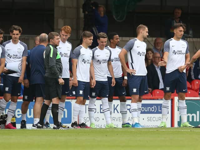 Preston North End substitutes prepare to come on against Accrington