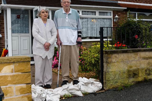Marina Grove residents Doris and Harold Johnson are doing whatever they can to protect their property from flooding - but it can be an exerting business