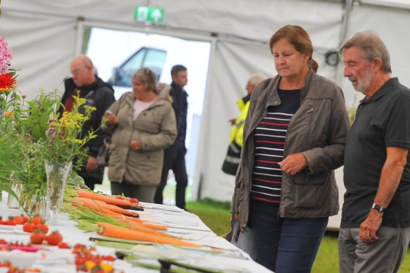 Visitors admire the competition fruit and vegetables on display.