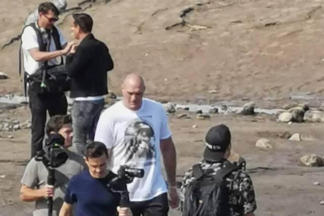 The famous pair were joined by a camera crew for a stroll along the beach as the 32-year-old heavyweightchatted with Gary Nevilleahead of his hugely anticipated title fight against Deontay Wilder in October. Pic: Ian Lane