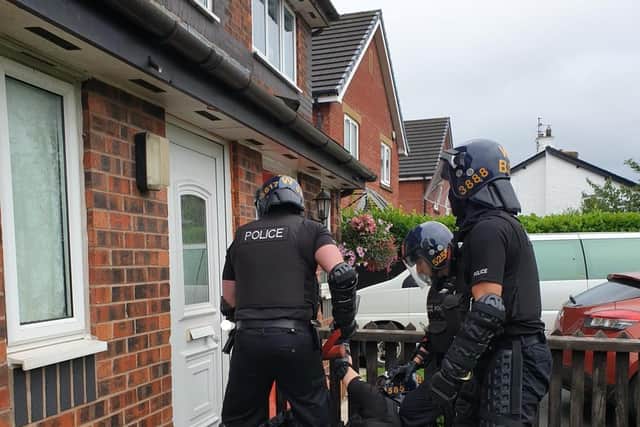 Officers used the 'big red key' to smash their way inside the home in Catterall this morning (Friday, August 6)