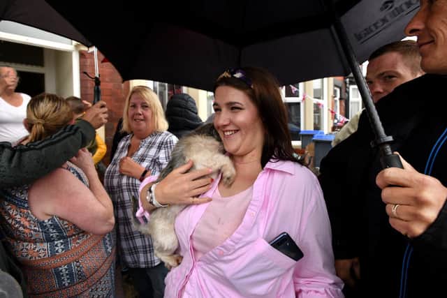 Jess Cook (centre) is greeting by pals as she arrives home in Blackpool