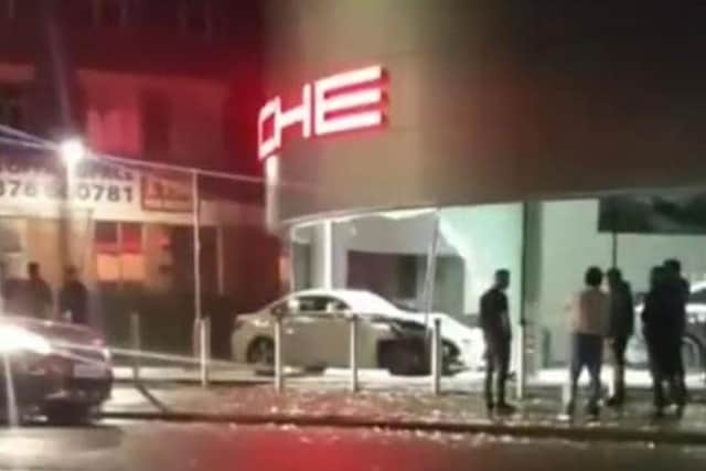 Pictures shared to social media showed the white BMW had smashed through the glass