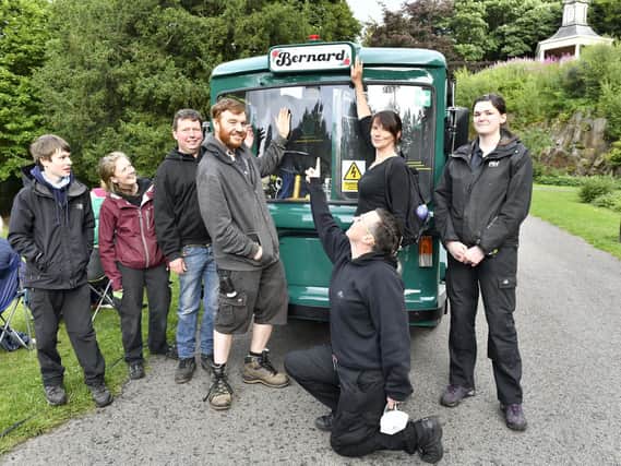 Bernard Gladstone's daughter, Karen Chandisingh, unveils the restored milk float named after him, watched by The Dukes technical team.