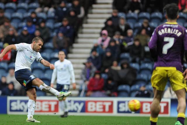 John Welsh has a shot for PNE against Notts County as Jack Grealish looks on