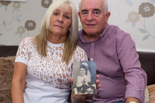 Lesley and her husband Martin with a picture of her mum Marie