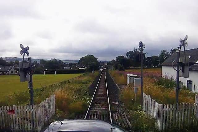 CCTV footage caught the moment a car narrowly missed being hit by a train in the Lake District. (Credit: Network Rail)