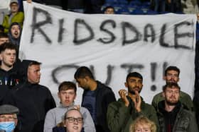 Fans display a banner at the end of the game
