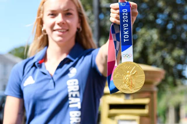 Anna Hopkin proudly shows off her gold medal from the Tokyo Olympics
