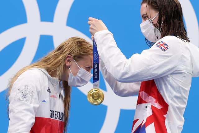 Gold medalist Kathleen Dawson places the medal of Anna Hopkin around her neck during the medal ceremony for the  Mixed 4 x 100m Medley Relay Final - Picture Getty Images