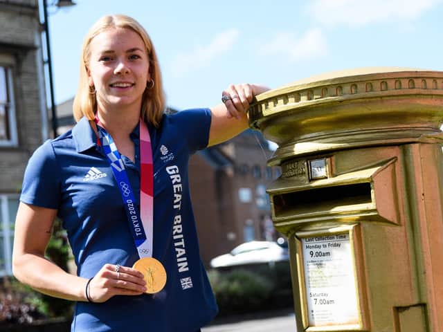 Anna Hopkin shows off her medal next to the gold post box in Chorley, painted in tribute to London 2012 Olympic champion Bradley Wiggins, who then lived in the borough - Picture Kelvin Stuttard