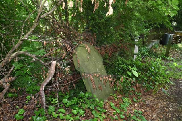 A 17th century gravestone on the inside of the boundary wall.