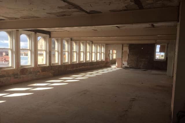The upper floors of the building lie derelict and empty. Photo by Walker and Williams.