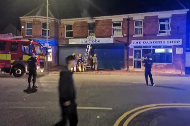 Fire crews used ladders to help rescue people from the flats, with residents seen climbing out of windows to escape the fire and smoke. Pic: Mike Swanson