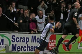 Ryan Ledson celebrates with the fans after scoring against Morecambe