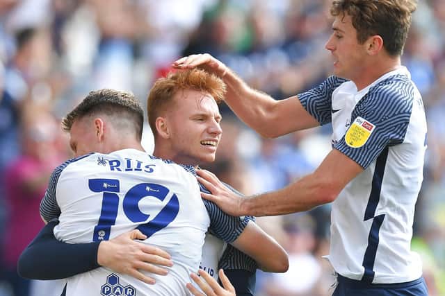 Sepp van den Berg is congratulated by Preston team-mates Emil Riis and Ryan Ledson after scoring against Swansea