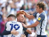 Sepp van den Berg is congratulated by Preston team-mates Emil Riis and Ryan Ledson after scoring against Swansea