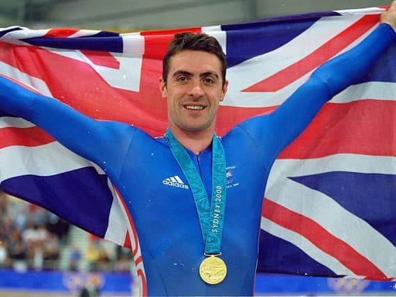 Jason Queally flies the flag for Great Britain after winning gold in the Men's 1km Time Trial final at the Dunc Gray Velodrome during Day One of the Sydney 2000 Olympic Games Picture: Getty Images