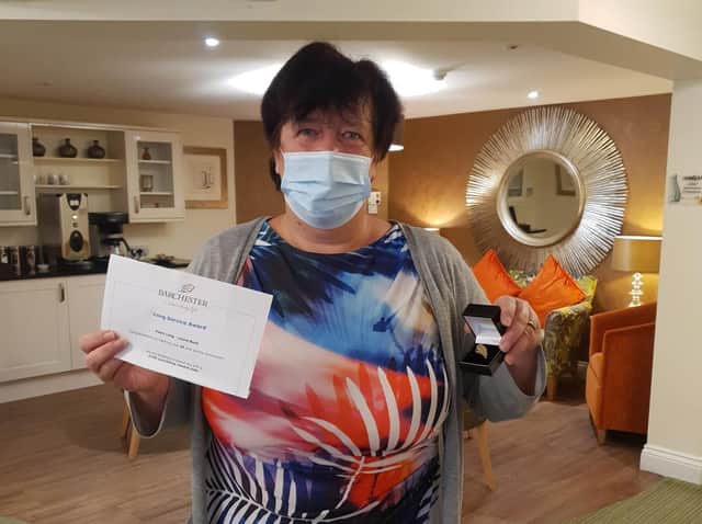 Dawn Long with her 25 years service award at Laurel Bank care home in Lancaster.