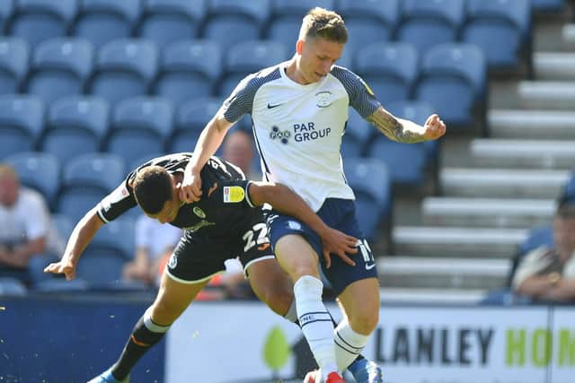 Preston North End striker Emil Riis takes on a Swansea defender at Deepdale