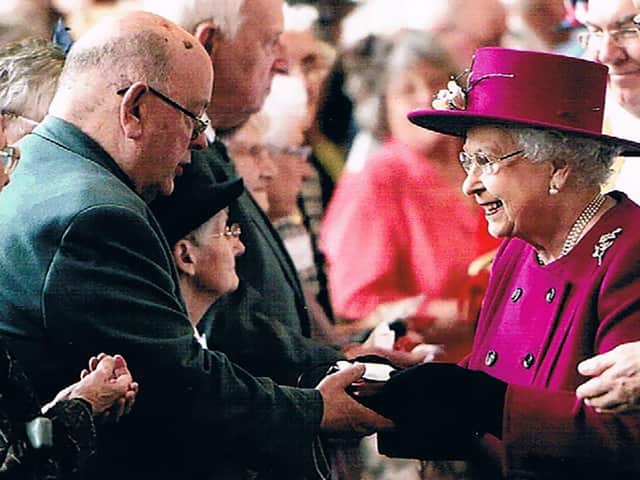 Canon Ron Greenall receiving Maundy money from HR Queen Elizabeth II at Blackburn Cathedral